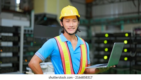 Young Asian Engineer Smiling At Camera With Laptop On His Hand In Mining Farm Factory