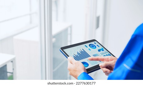 Young Asian engineer using a tablet PC in room. Maintenance staff. - Powered by Shutterstock - Get 15% off with code: PIKWIZARD15