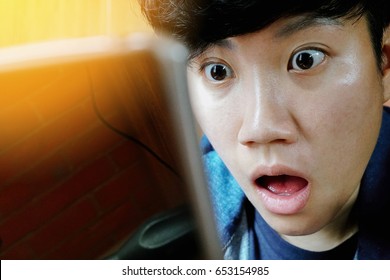 Young Asian Face Have Surprise And Shocking Expression On When Looking At Smartphone Screen