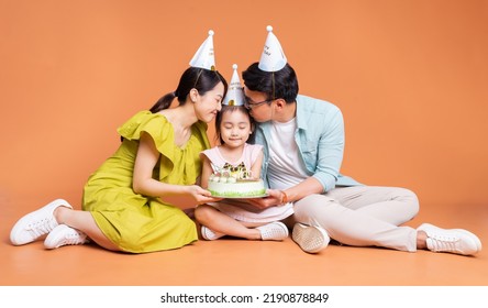 Young Asian Family Posing On Background