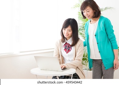 Young Asian Family Relaxing In The Room