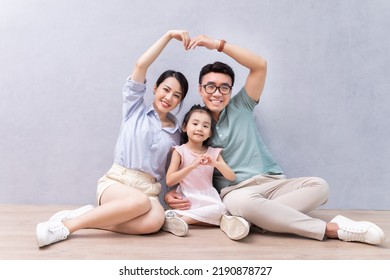 Young Asian Family Sitting On The Floor