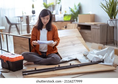 Young Asian Female Assembling Furniture By Herself