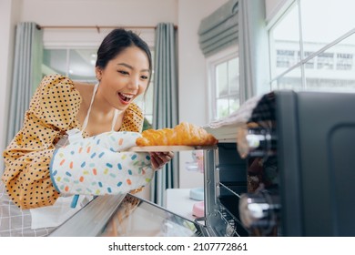 Young Asian Female Baking Croissant Bread Preparing Breakfast, Food And Cuisine Concept