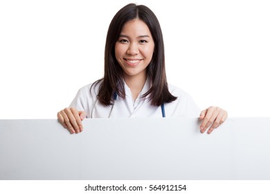 Young Asian Female Doctor Show Thumbs Up  Behind Blank White Billboard Isolated On White Background.