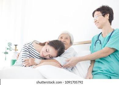 Young Asian Female Hug Old Female Patient, Mother's Day , Family Time, Palliative Care In Hospital