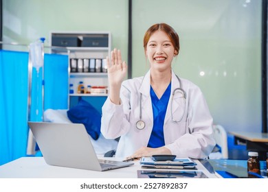 young Asian female medical doctor in white lab coat reviews patient x-ray films on her computer during online consultation. She provides reliable medical recommendations for heart and lung diseases. - Powered by Shutterstock