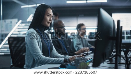 Young Asian Female Software Developer Working on Computer Together with Diverse Creative Colleagues. Data Protection Center with Servers, Storage Hardware and Cyber Security Research