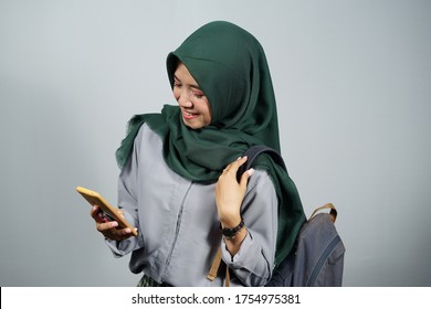 Young Asian Female Student Wearing Green Hijab And Grey Clothes