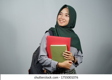 Young Asian Female Student Wearing Green Hijab And Grey Clothes