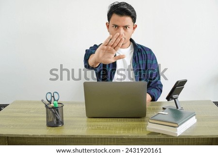 young asian freelancer in workplace making stop sign with hands isolated on white background