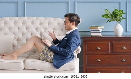 Young Asian funny businessman wearing underwear boxer work at home and virtual video conference meeting with colleagues business people, online working, video call at home office - Powered by Shutterstock