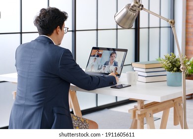 Young Asian Funny Businessman Wearing Underwear Boxer Work At Home And Virtual Video Conference Meeting With Colleagues Business People, Online Working, Video Call At Home Office