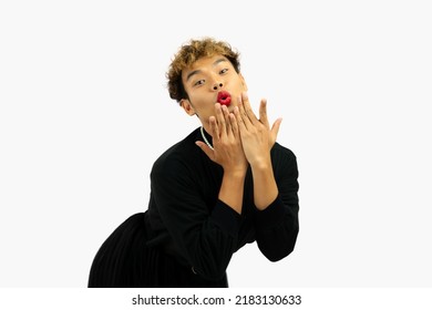 Young Asian Gay Man In Black Dress Wearing Necklace Posing Happy And Kissing On The White Screen Background.