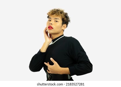 Young Asian Gay Man In Black Dress Wearing Necklace Posing  On The White Screen Background, Lgbt Or Lgbtq Concept.