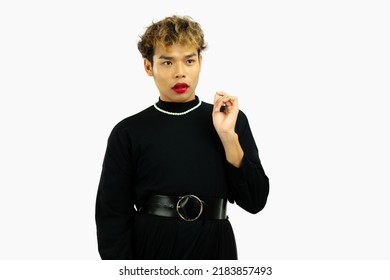 Young Asian Gay Man In Black Dress Wearing Necklace Posing On The White Screen Background.