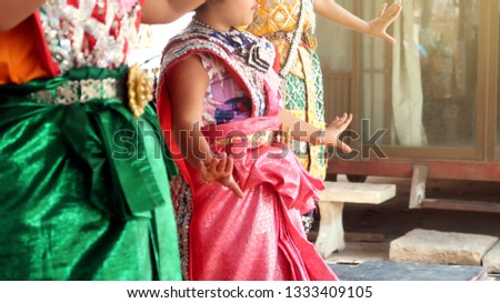 Young Asian girl dancing in Thai traditional style, kid's activity on free-time to promoter the arts of Thai culture traditional. Buddhism religion.
