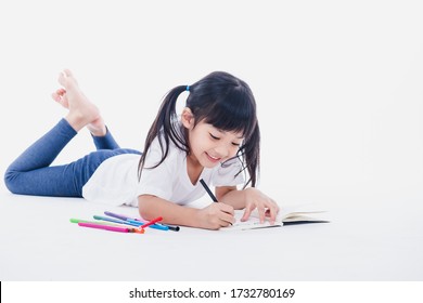 A Young Asian Girl Drawing A Picture. On White