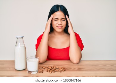 Young Asian Girl Drinking Healthy Almond Milk With Hand On Head, Headache Because Stress. Suffering Migraine. 