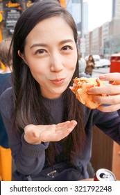 Young Asian Girl Eating Hotdog