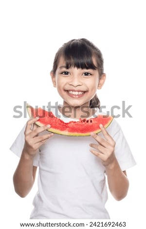 Young Asian girl eating watermelon isolated on white background with clipping path.