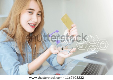 young asian girl happy using credit card to online shopping in the office concept.