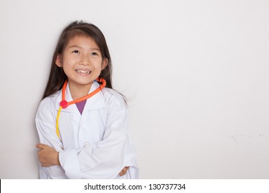 A Young Asian Girl Having Fun Playing Dress Up As A Doctor