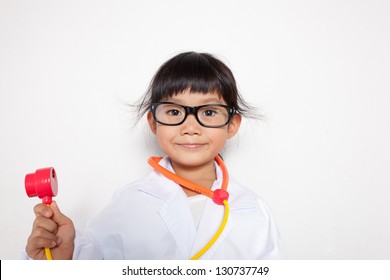 A young asian girl having fun playing dress up as a doctor - Powered by Shutterstock