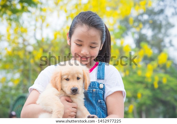 Young Asian Girl Hugging Little Golden Stock Photo (Edit Now) 1452977225