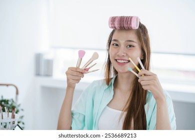 Young Asian girl makeup artist Professional Woman blogger vlogger is showing cosmetics products with recording video Beauty influencer asian girl video online marketing - Powered by Shutterstock