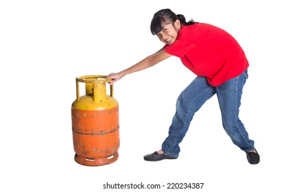 Young Asian Girl Moving An Old Cooking Gas Propane Cylinder Over White Background