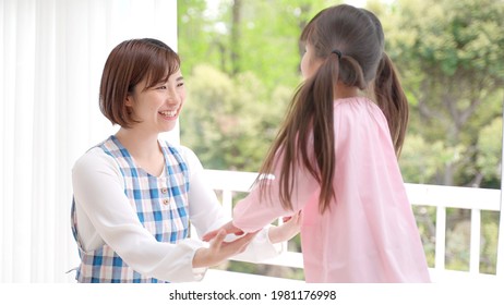 Young Asian Girl Playing With A Nursery Teacher
