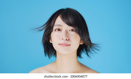 Young Asian Girl With Short Hair Fluttering In The Wind