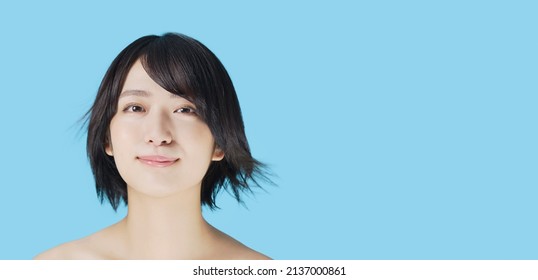 Young asian girl with short hair fluttering in the wind