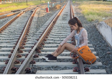 Young asian girl sit and wait on the rail road - Shutterstock ID 505038211