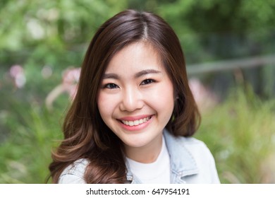 Young Asian Girl Smiling In The Garden