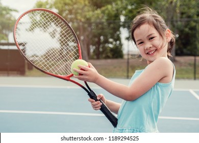 Young Asian Girl Tennis Beginner Player On Outdoor Blue Court, Kid Active Sport