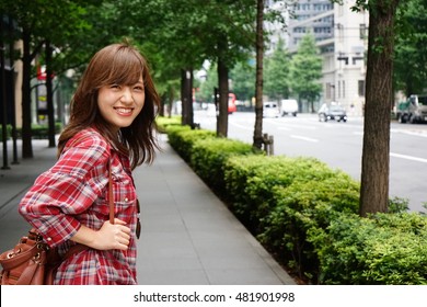 Young Asian girl traveling alone with smile