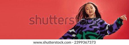young asian girl in vibrant sweater with animal print with heart shaped necklace on red, ease banner