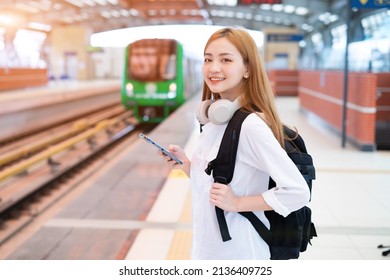 Young Asian Girl Waiting For The Train At The Station
