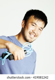young asian guy with skipping rope on white background ready to training sport, lifestyle people concept
