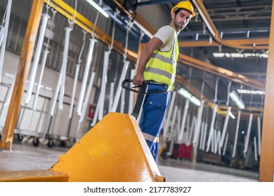 Young Asian handsome male industrial worker work in warehouse factory. Attractive industry factory engineer people wear helmet and processes orders and product at manufacturing plant with happiness. - Shutterstock ID 2177783927