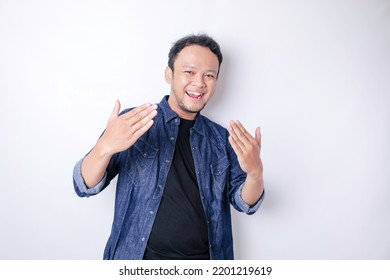 Young Asian handsome man over isolated white background inviting to come with hand. Happy that you came - Powered by Shutterstock