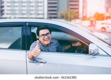 Young Asian Handsome Man Smiling And Showing Thumbs Up In His Car