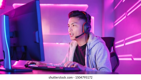 Young Asian Handsome Pro Gamer Playing In Online Video Game