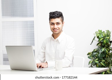 Young Asian Indian Businessman Working On Laptop In Office