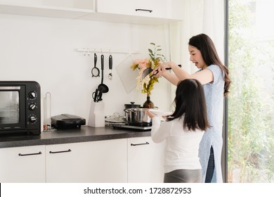 Young Asian Japanese Mom And Daughter Cooking At Home. Lifestyle Women Happy Making Pasta And Spaghetti Together For Breakfast Meal In Modern Kitchen At House In The Morning Concept.