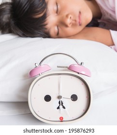 Young Asian Malay Girl Sleeping In Her Bed With An Alarm Clock