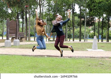 Young Asian Malay Man Woman Outdoor Green Park Joy Happy Jump In The Air