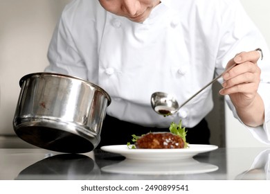 Young Asian male cook serving food on a plate - Powered by Shutterstock